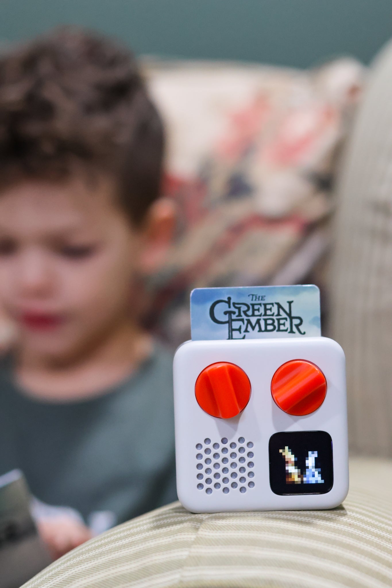Child reading Green Ember listening to Green Ember Yoto